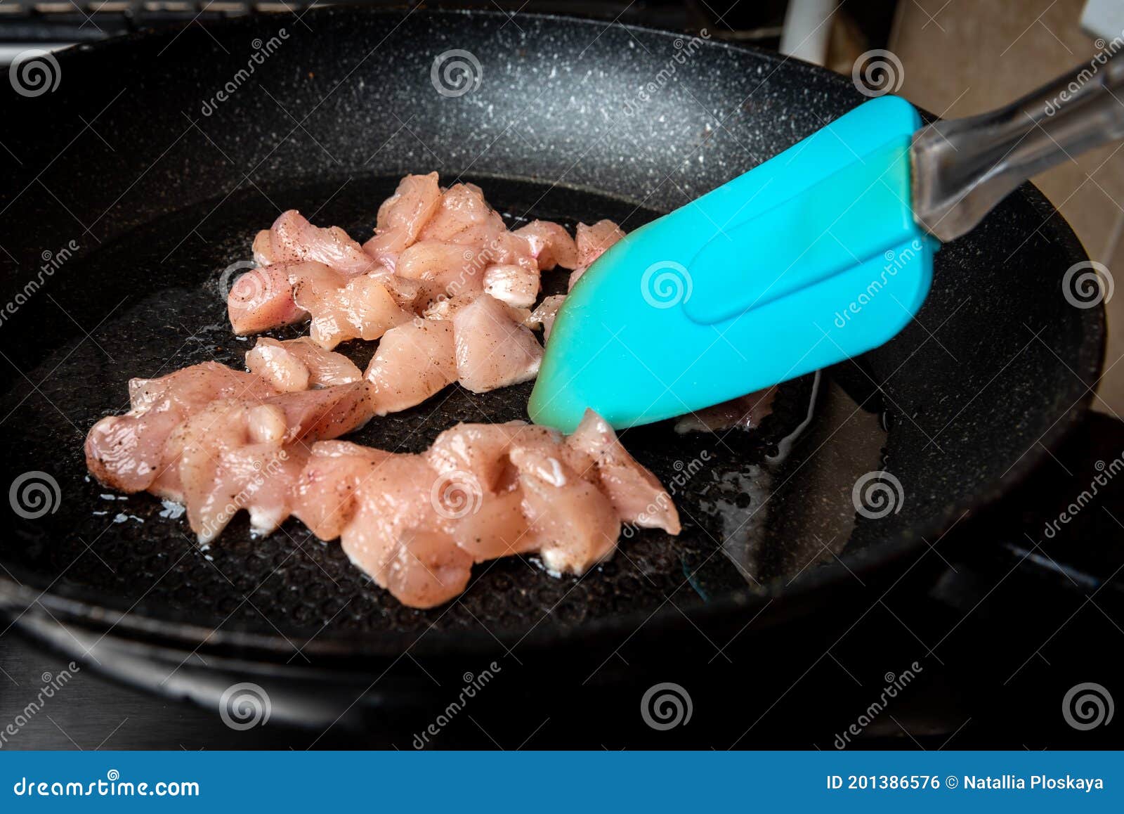 Frying Chicken Meat Cubes in a Pan on Stove. Stock Photo Image of