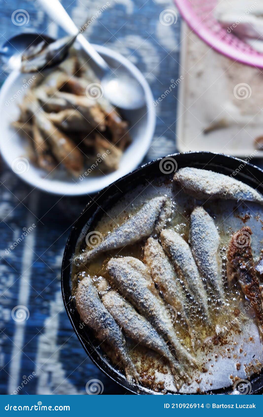 frying small sardines fish, chefchouen, morocco