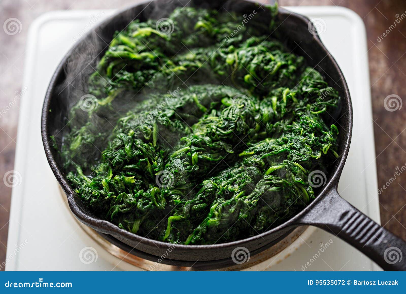 Frying Thawed Frozen Spinach on Iron Skillet Stock Photo Image of