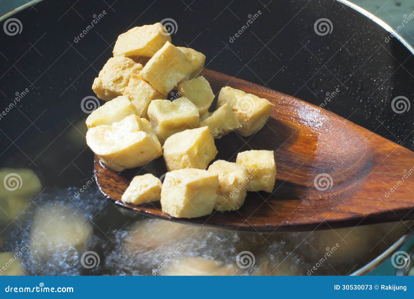Frying tofu with hot oil stock image. Image of fried 30530073