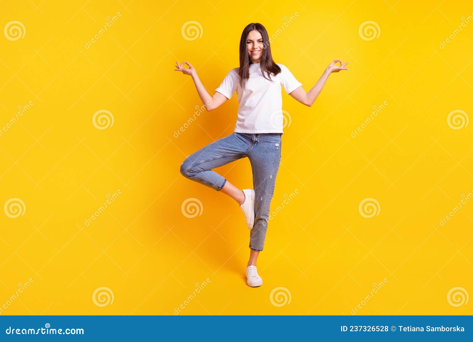 Full body photo of young charming girl meditate calm wear casual clothes isolated over yellow color background.