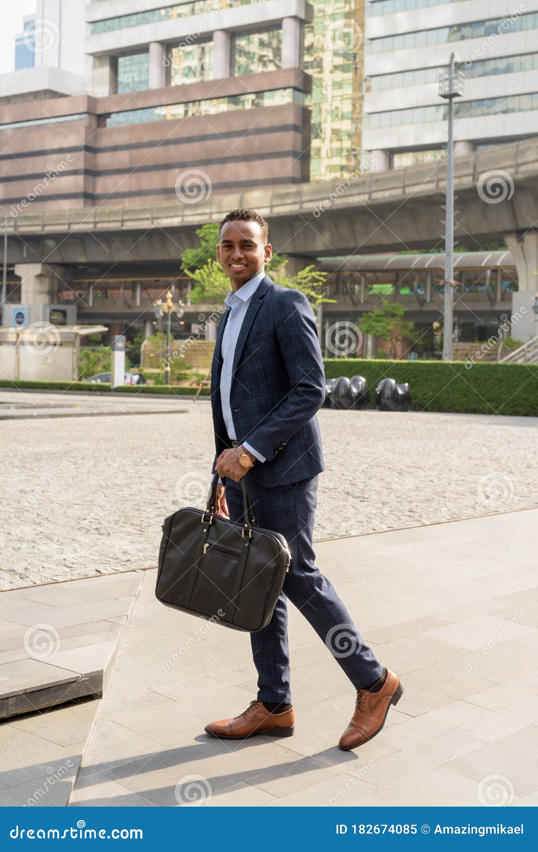 Full Body Shot of Happy Young African Businessman with Suitcase Walking ...