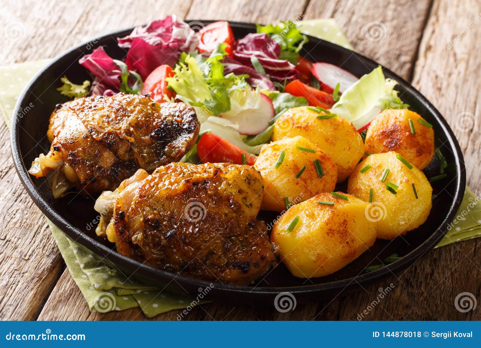 Full Dinner of Chicken Thighs with New Potatoes and Fresh Salad Close ...