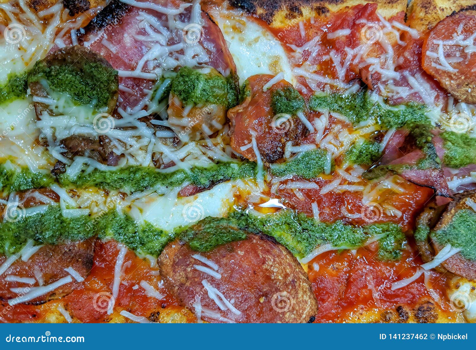Pepperoni and Pesto Pizza stock photo. Image of mozzarella 141237462