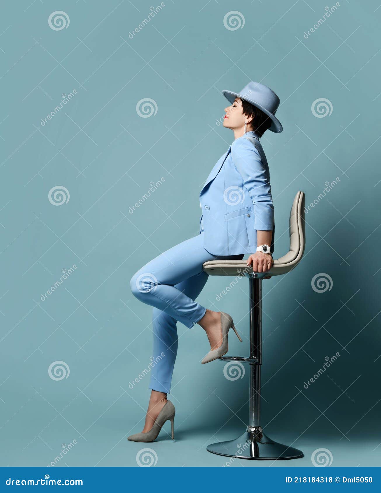 Full Growth Portrait Of Short Haired Brunette Woman In Blue Business Suit Hat High Heeled
