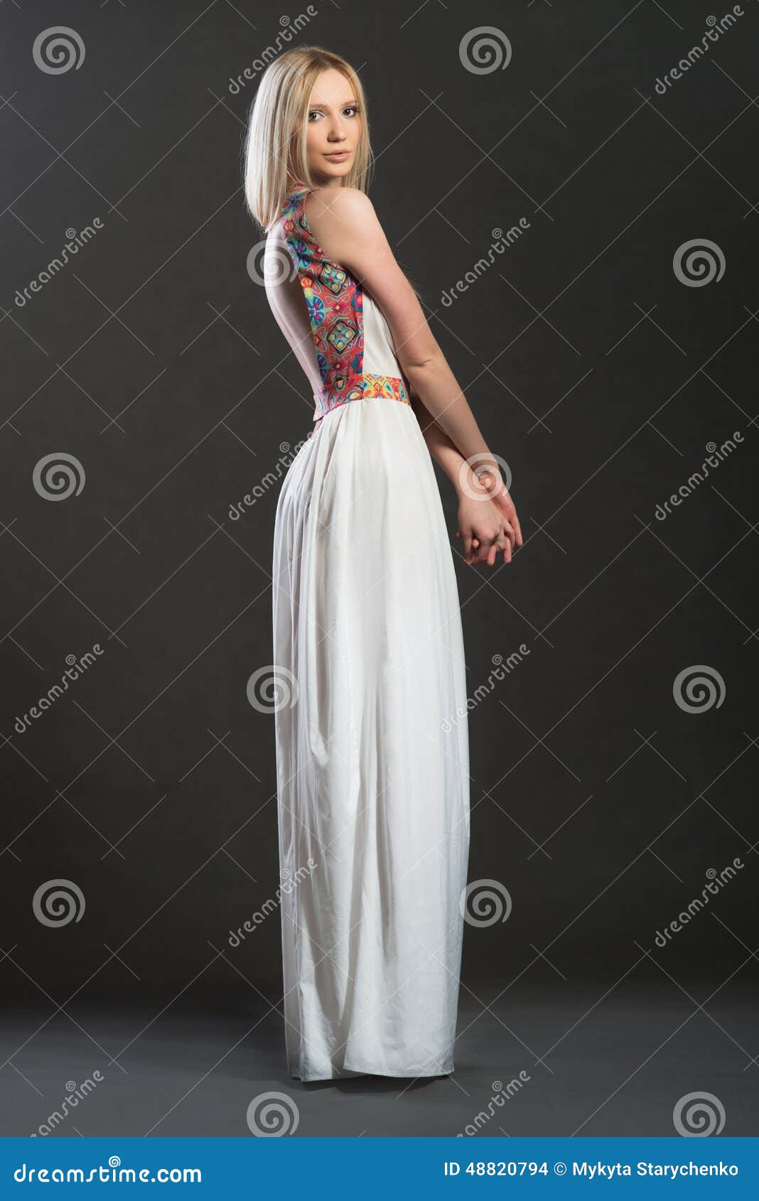 full-lenght portrait of bnonde woman in white long dress