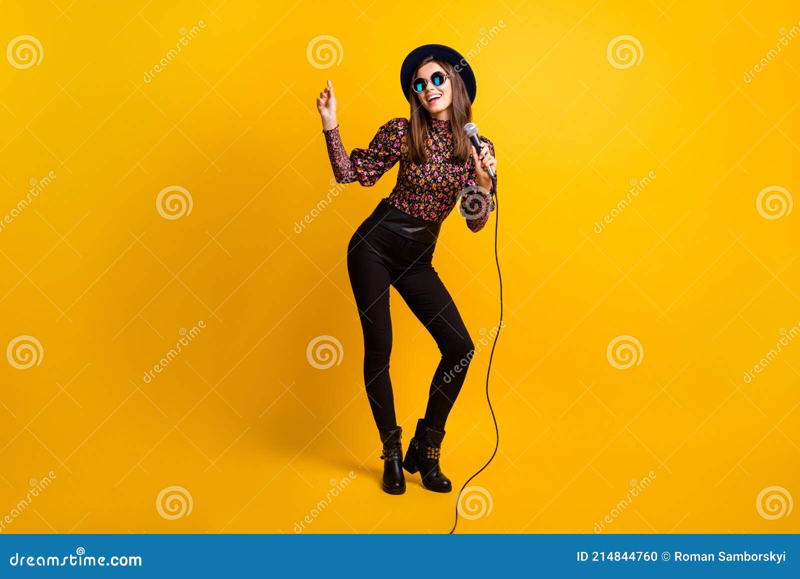 full length body size photo pop star keeping microphone dancing performing festival isolated bright yellow color full length 214844760