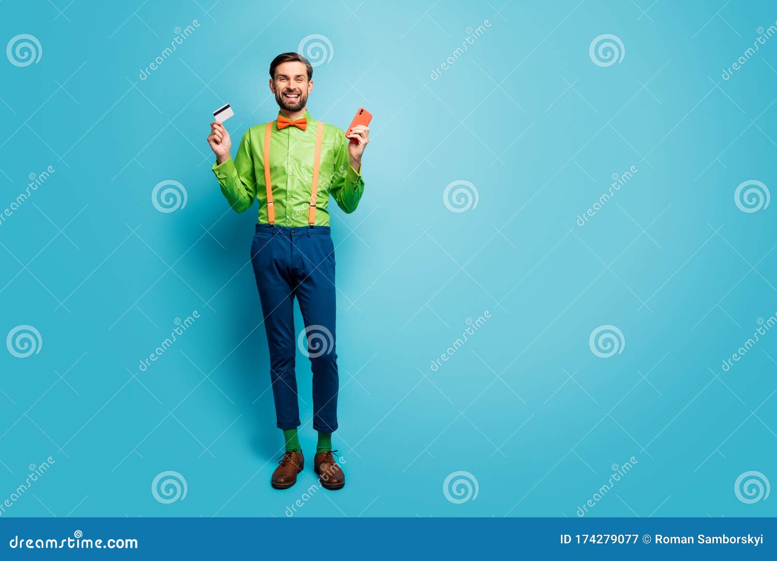 full length body size view of his he nice attractive cheerful guy using digital device fast payment  over bright