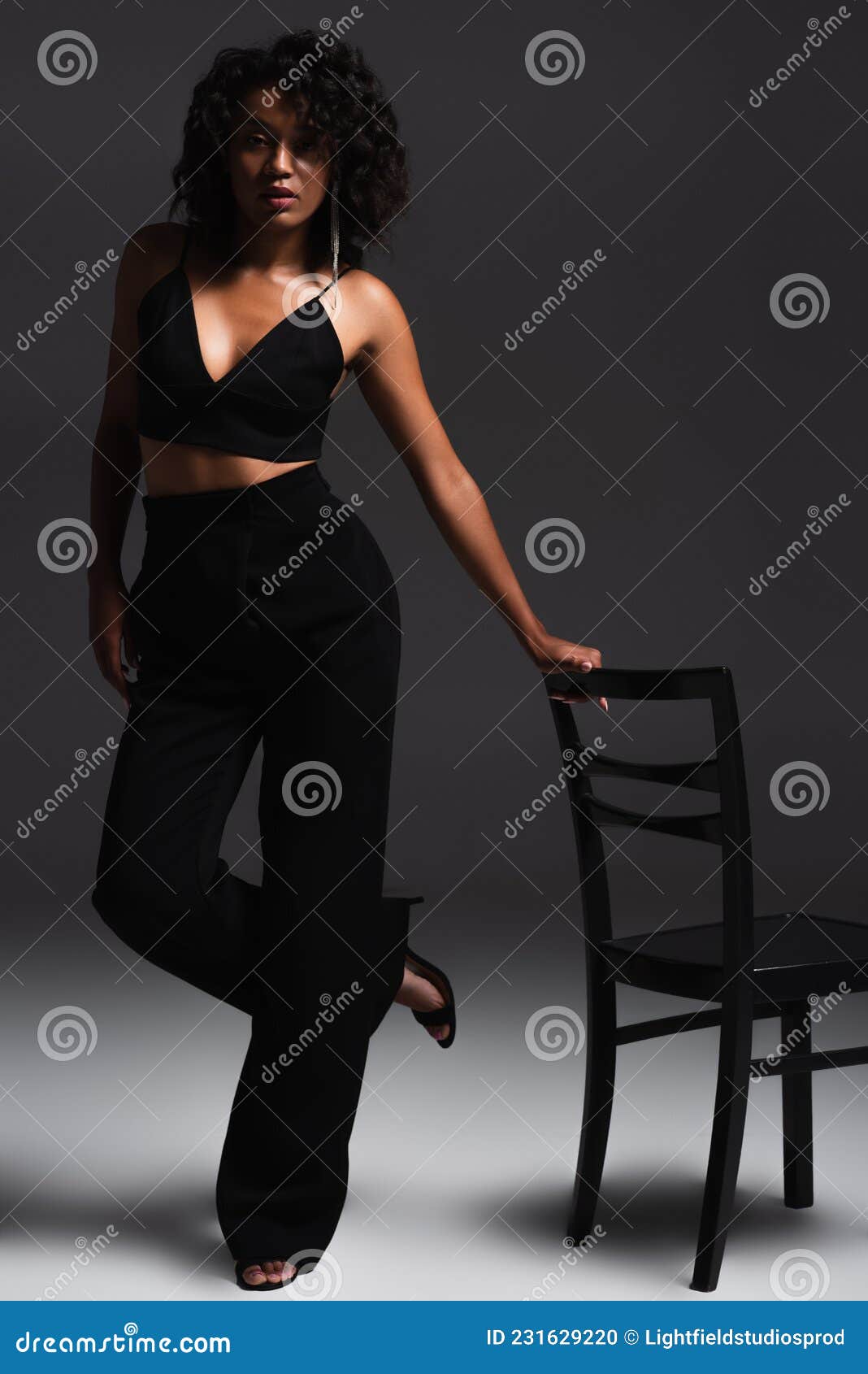 Full length of attractive woman in stylish clothing. African