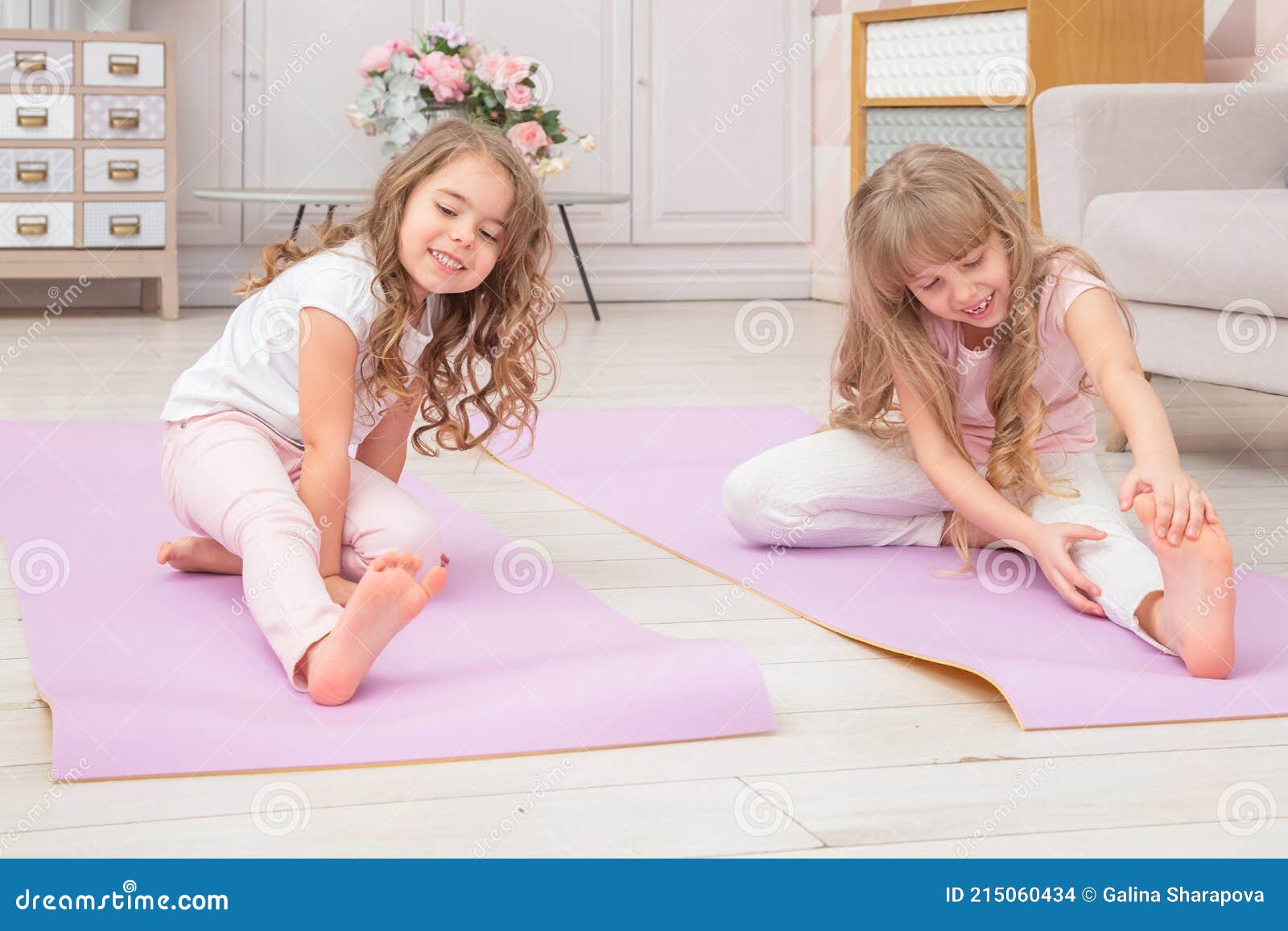 Full Length Front View Smiling Cute Girls Sitting on on Yoga Mat