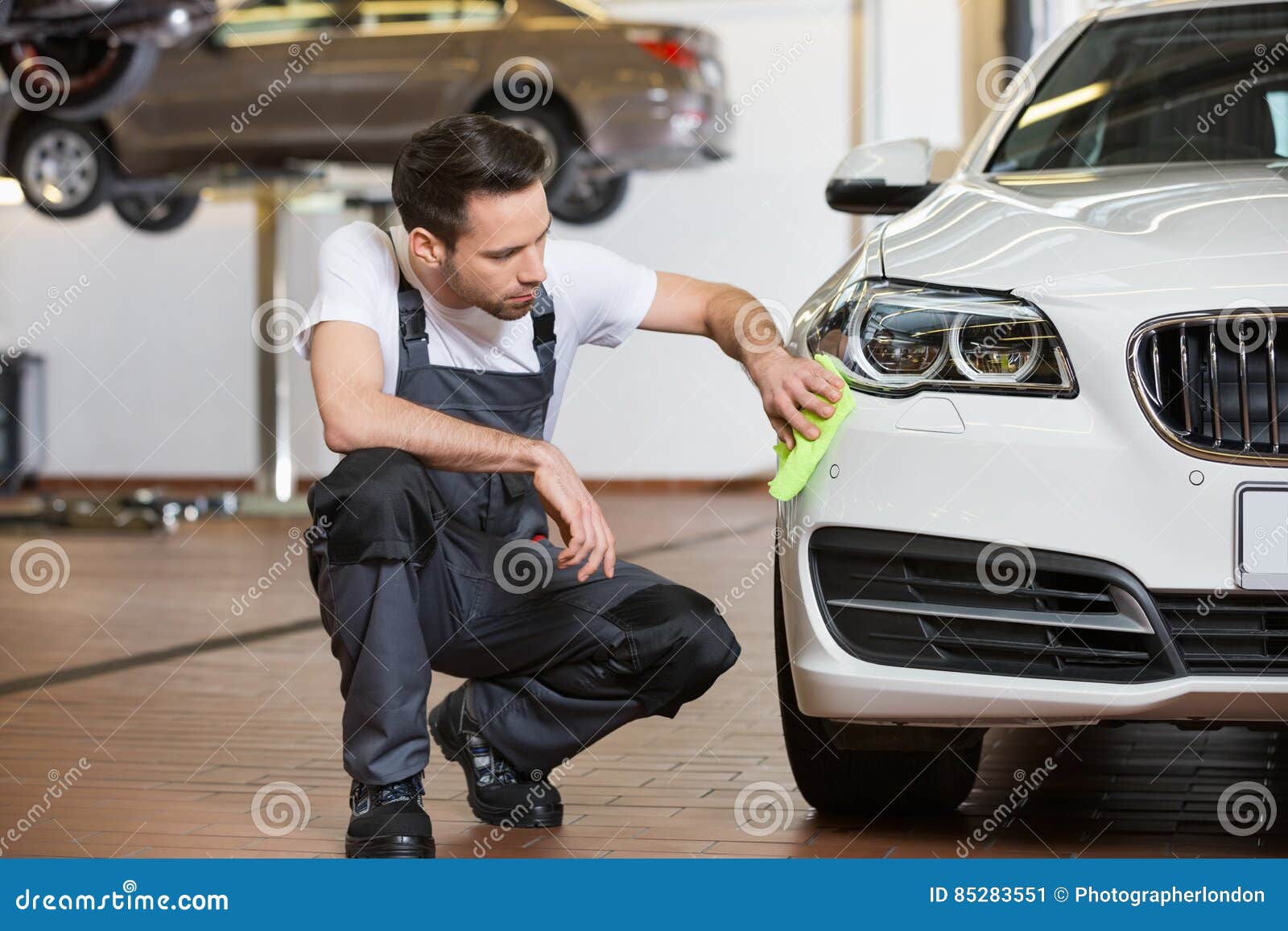 Full Length of Maintenance Engineer Cleaning Car in Stock