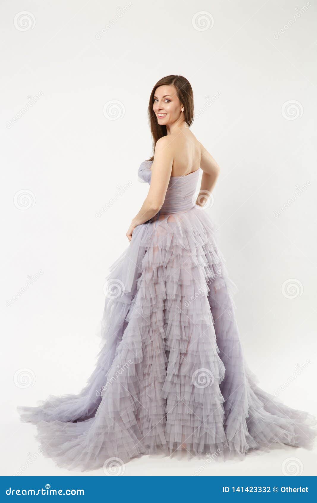 Premium Photo | A young woman in a sleeveless ball gown poses against an  isolated background a beautiful brunette wi...