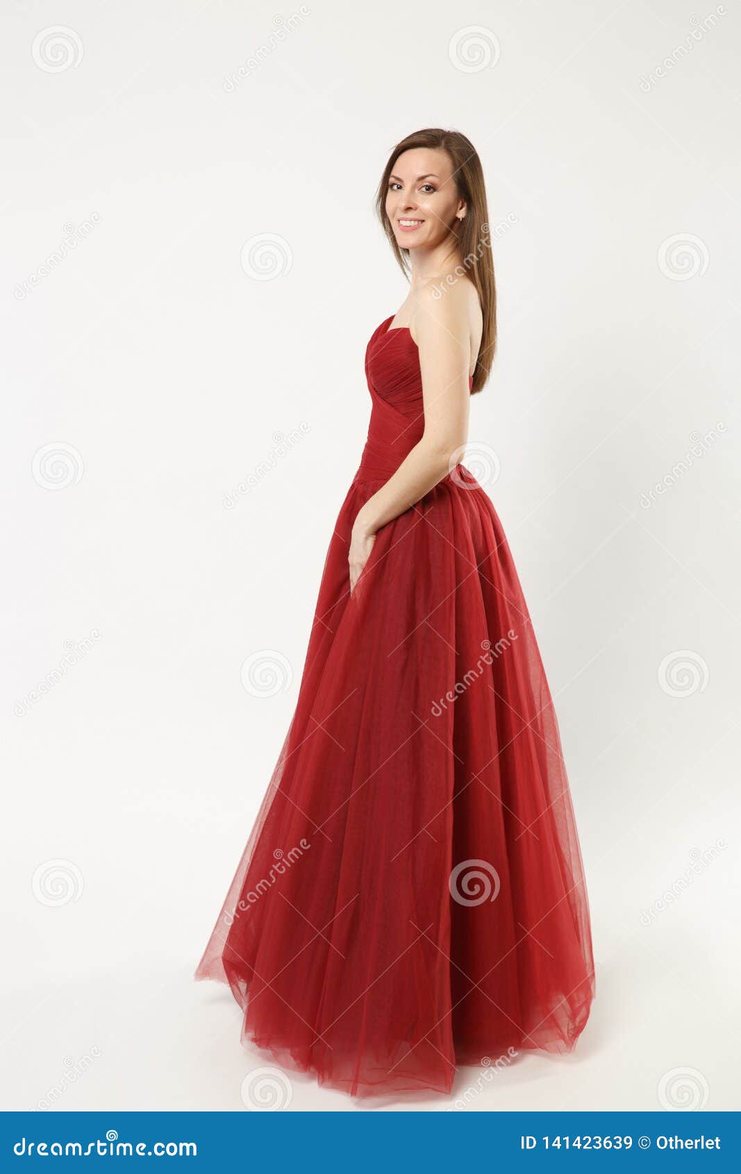 Full length photo of fashion model woman wearing elegant evening dress gown  posing isolated on white