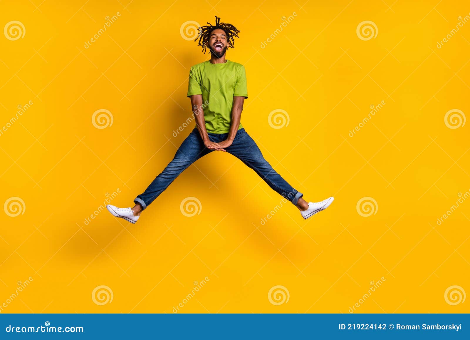 Full Length Photo Portrait Of Guy Jumping Up Spreading Legs Isolated On