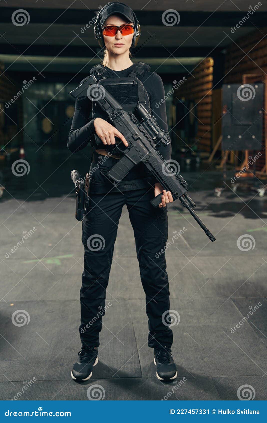 Serene Military Woman with a Firearm Looking Ahead Stock Image - Image