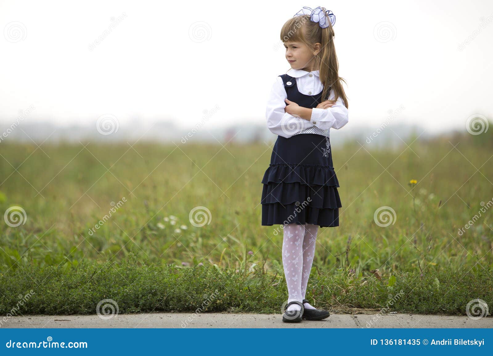 Full Length Portrait Of Cute Adorable Serious Thoughtful First Grader 