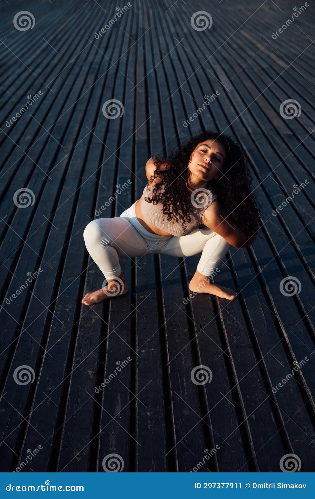 Women and men practicing yoga while lying on exercise mat in park
