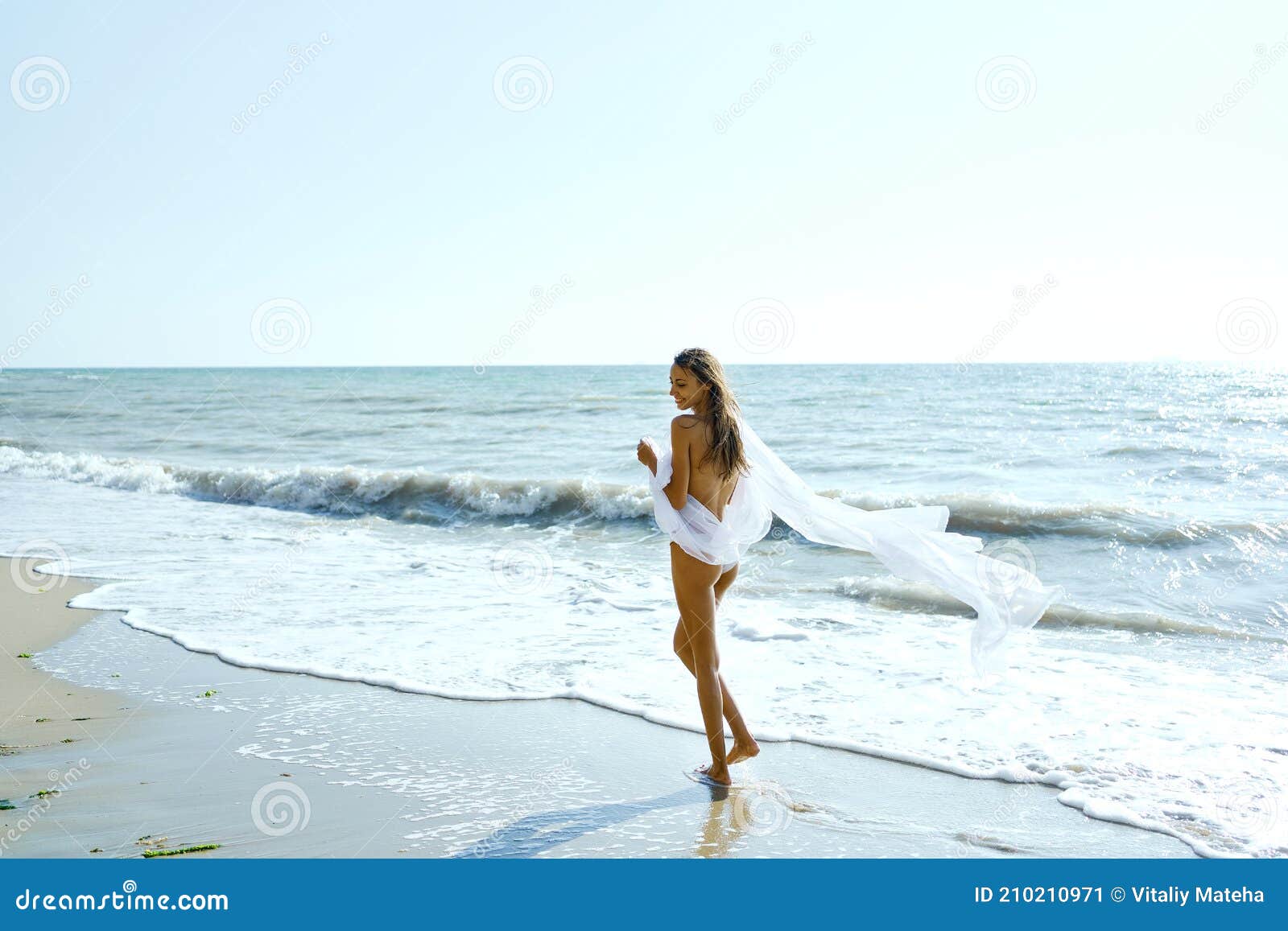 Naked girl running in water