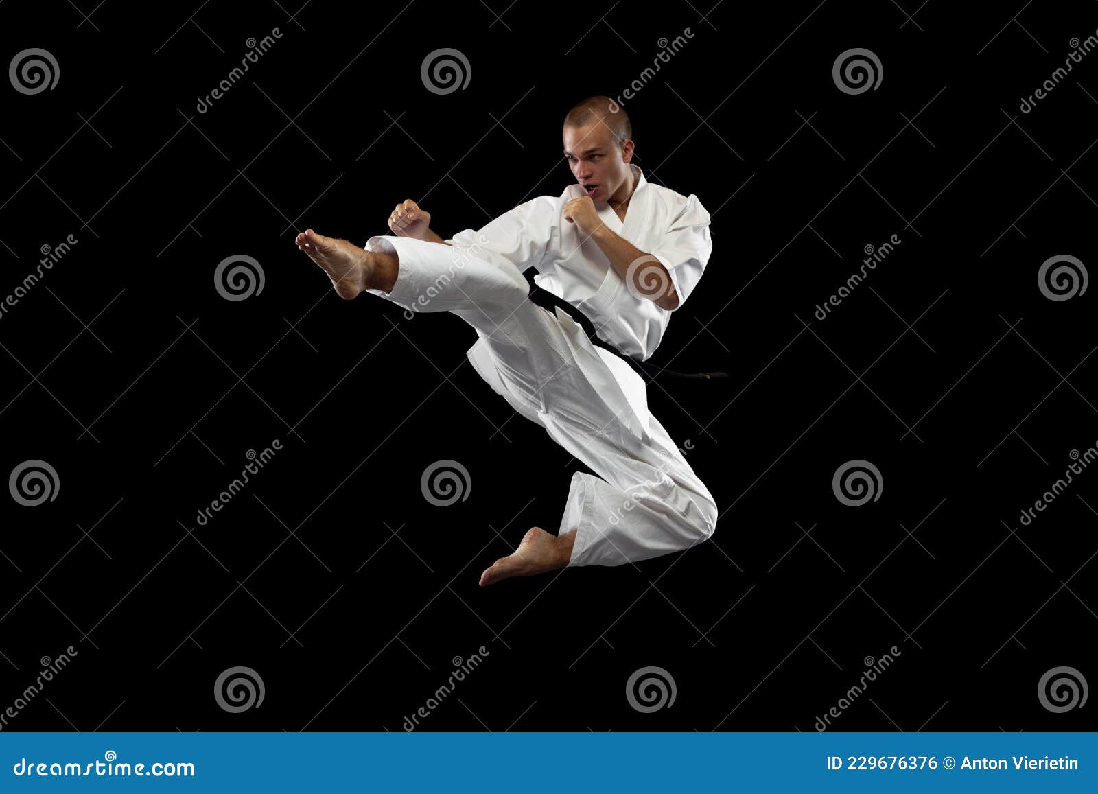 Full-length Portrait. One Young Karate Sportsman Training Isolated Over  Black Background Stock Photo - Image of hand, battle: 229676376