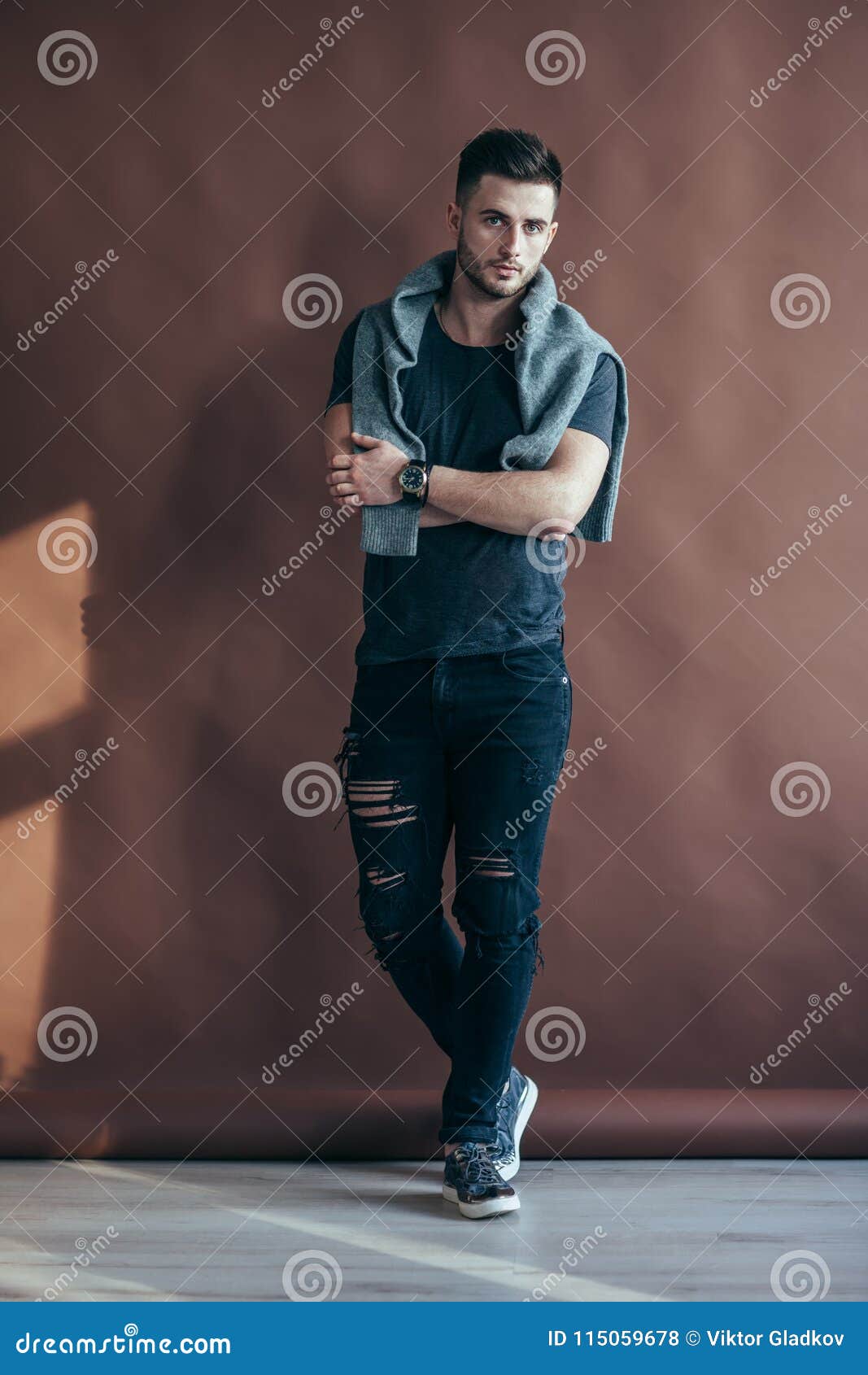 full length portrait of a muscular man with crossed arms po