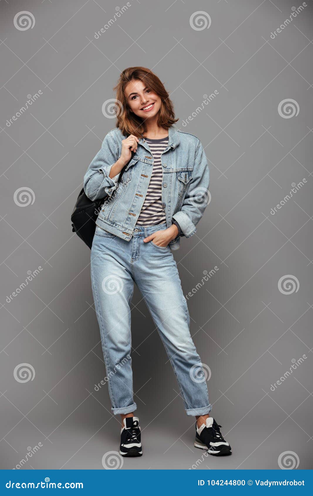 Young stylish brunette girl on shirt, pants, jeans jacket posed background  iron fence. Street fashion model concept. 6631557 Stock Photo at Vecteezy