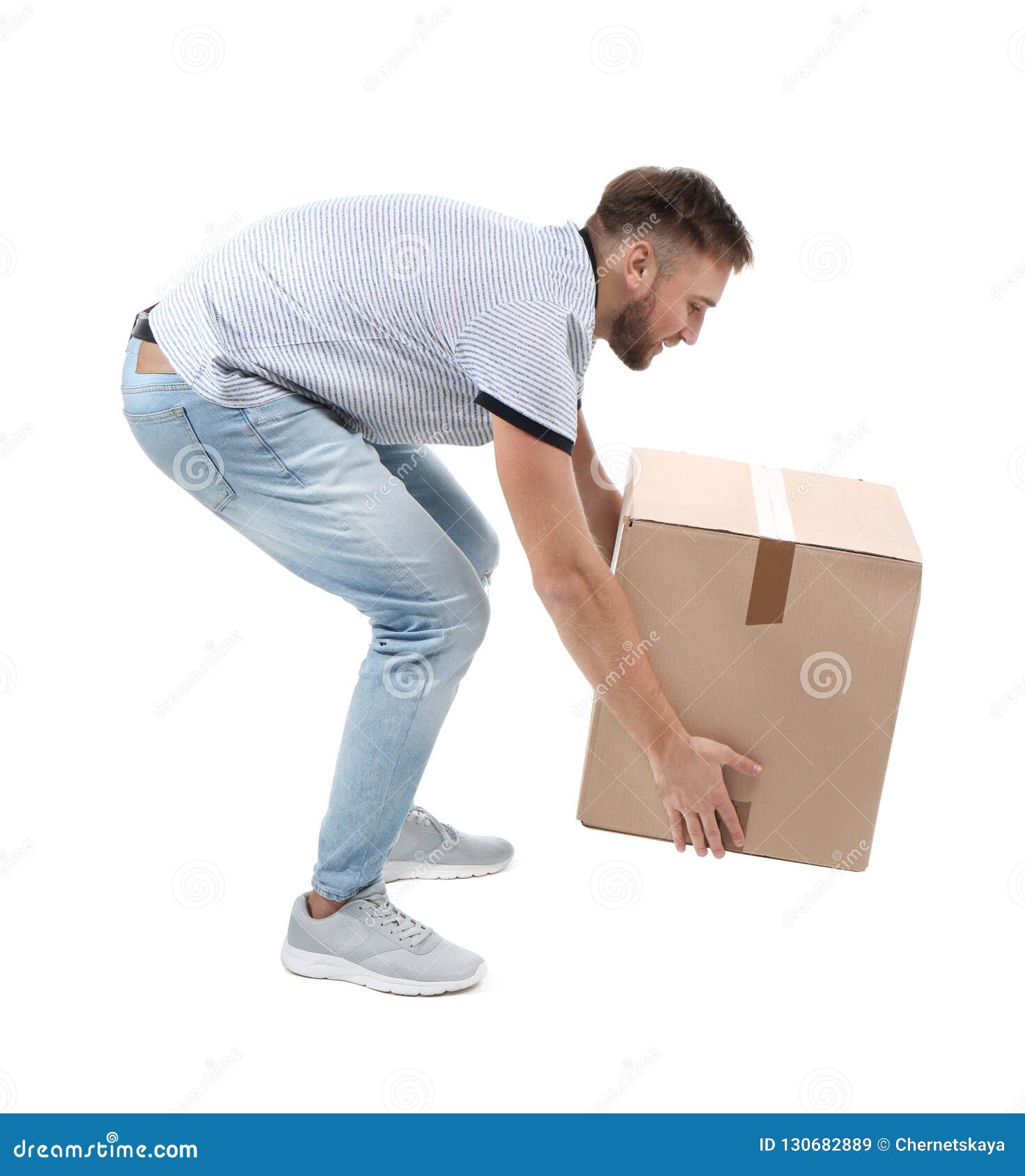 full length portrait of young man lifting carton box