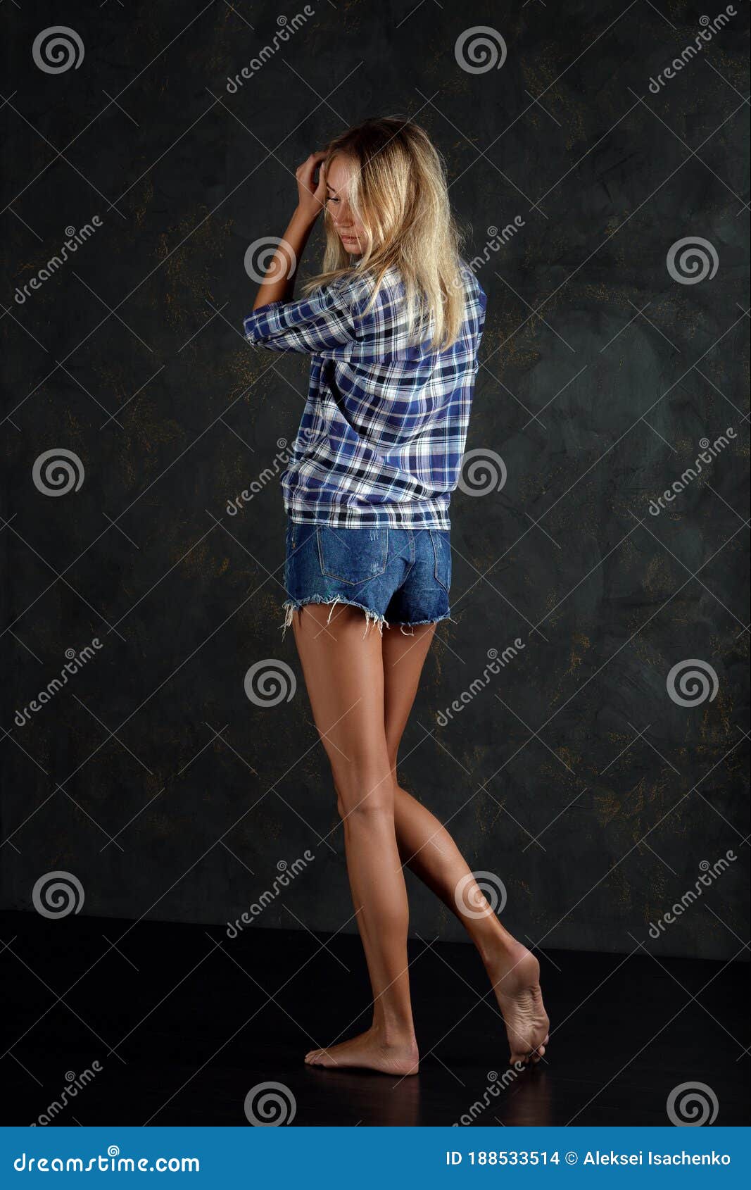 Full Length Portrait Of Young Woman In Jeans Shorts Blue Checked Shirt Bare Feet And With No