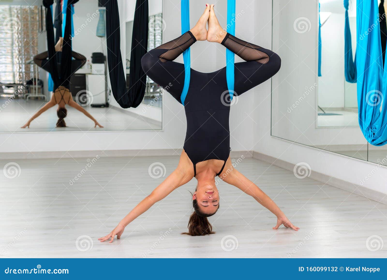 attractive young woman at aero yoga session in gym
