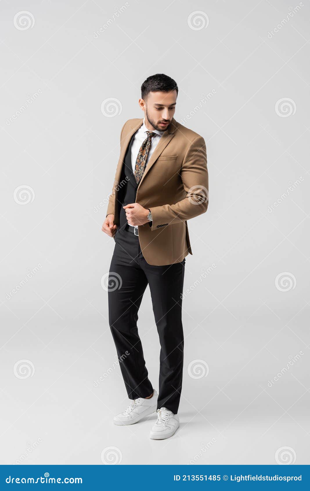 full length view brunette arabian full length view brunette arabian man trendy suit sneakers posing grey stock 213551485