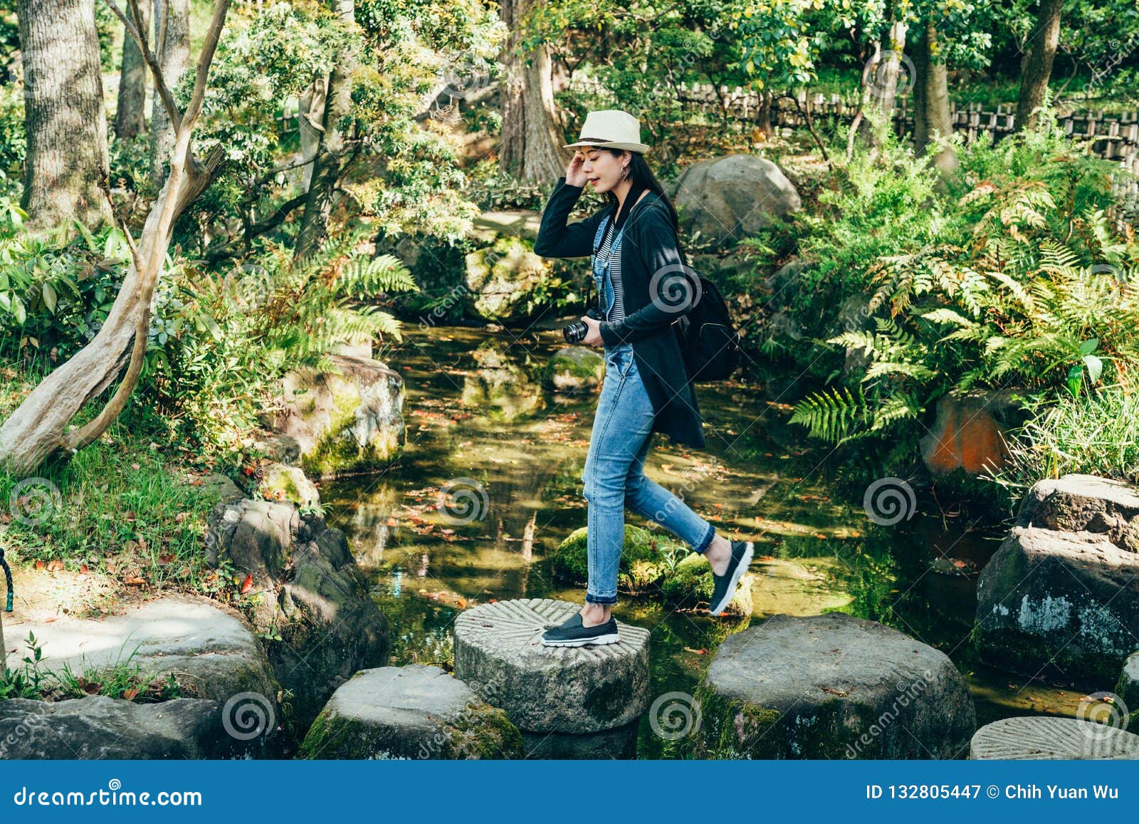 young girl walking in nihon teien on sunny day