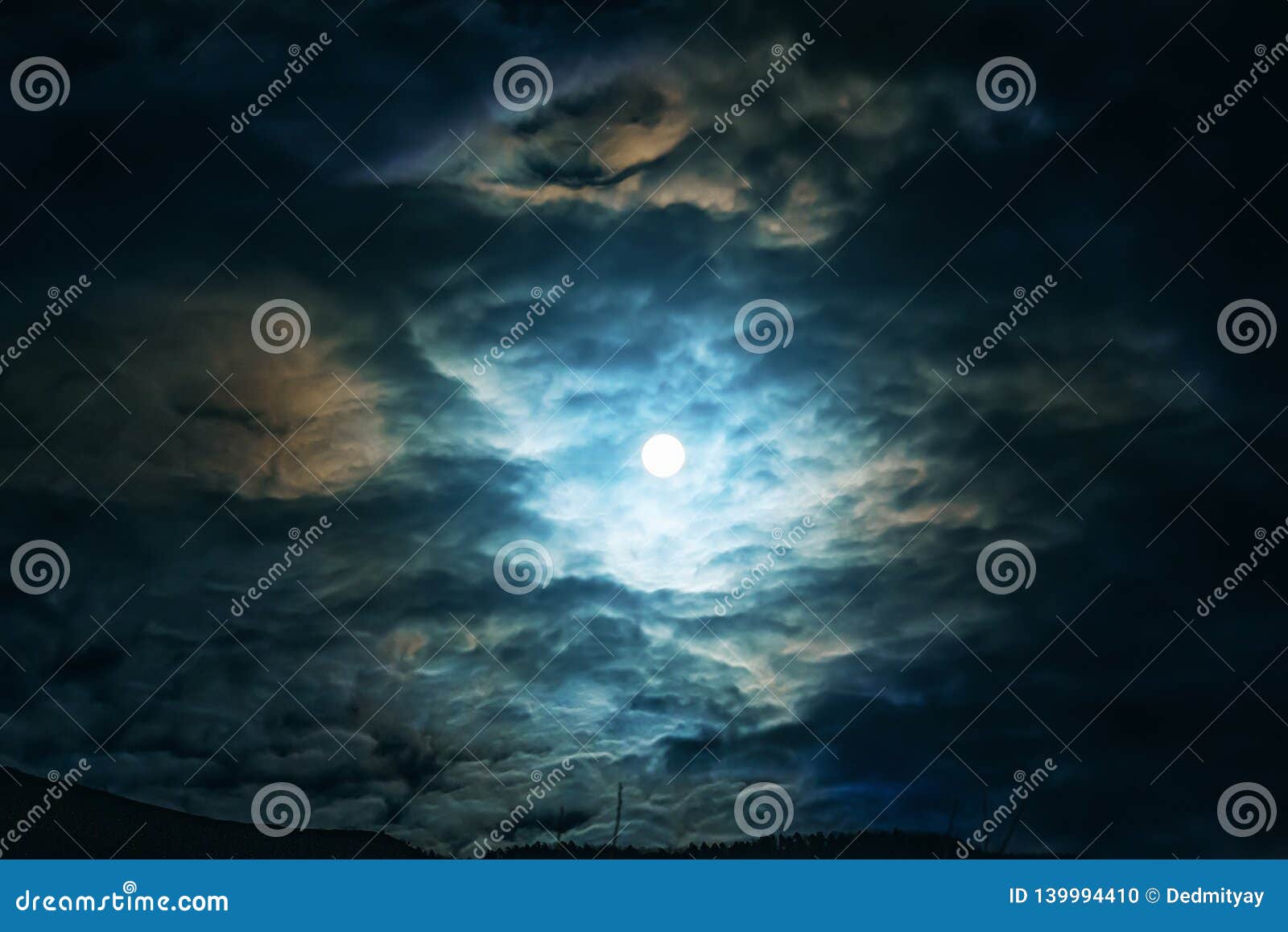 full moon or supermoon in night blue sky with clouds, dramatic mysterious atmosphere