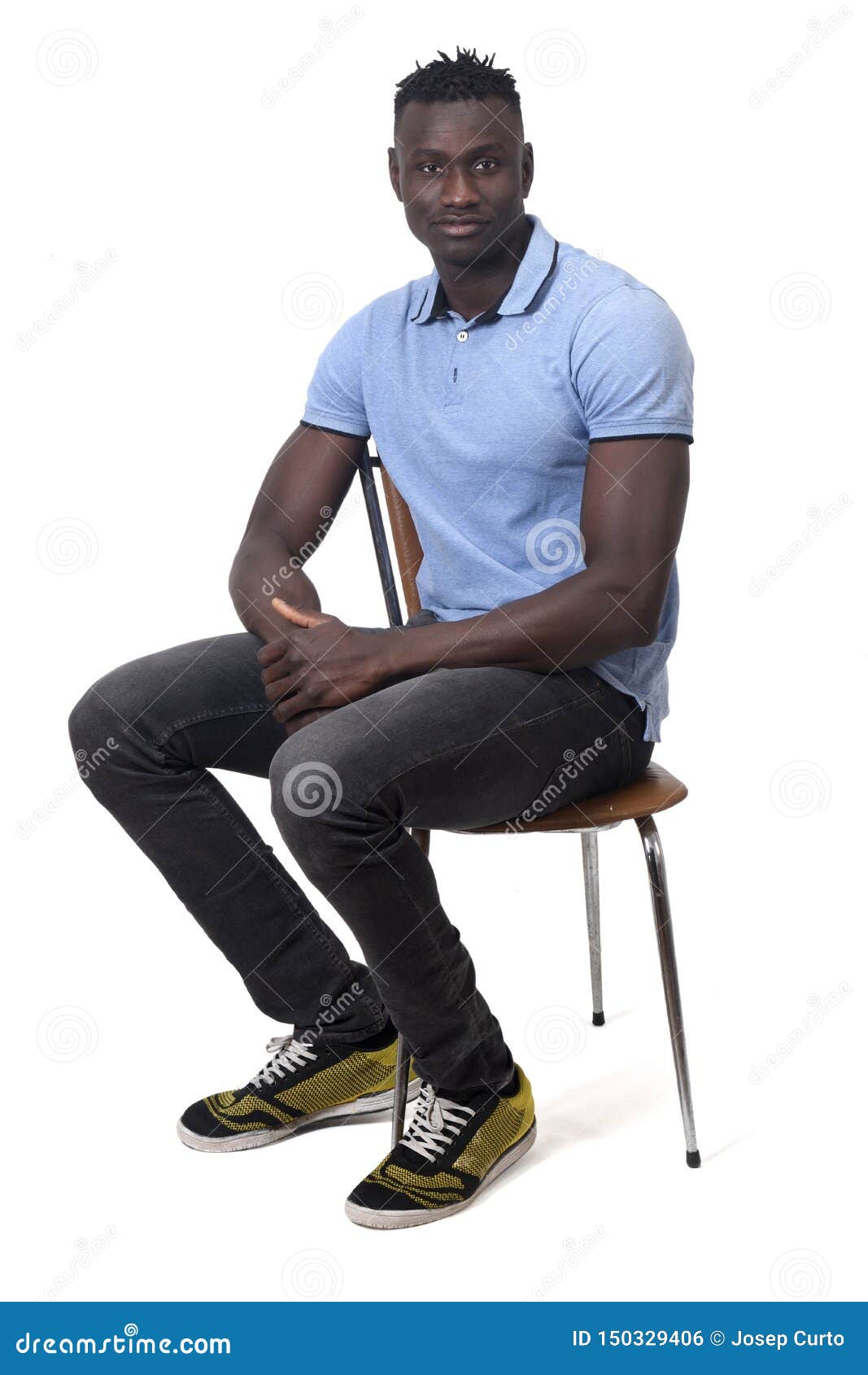 Full Portrait of African Man Sitting a Chair on White Background Stock