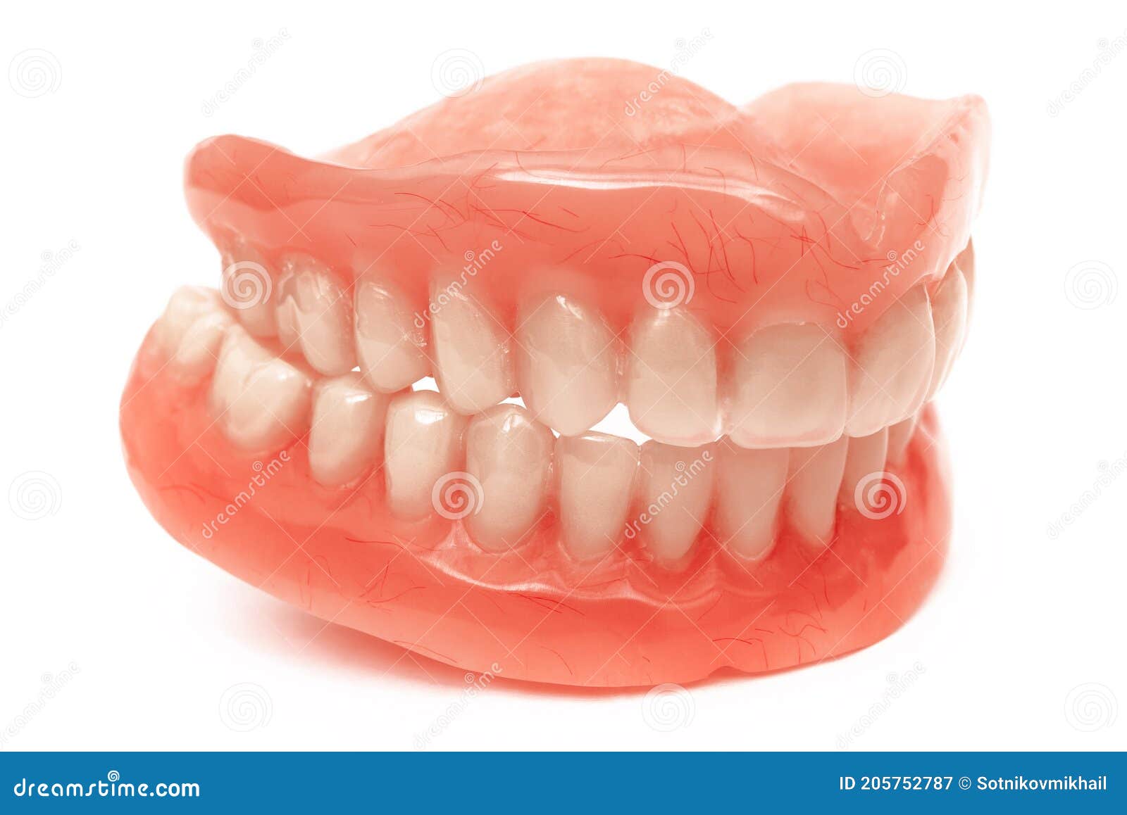 Full Removable Plastic Denture of the Jaws. Set of Dentures on a White