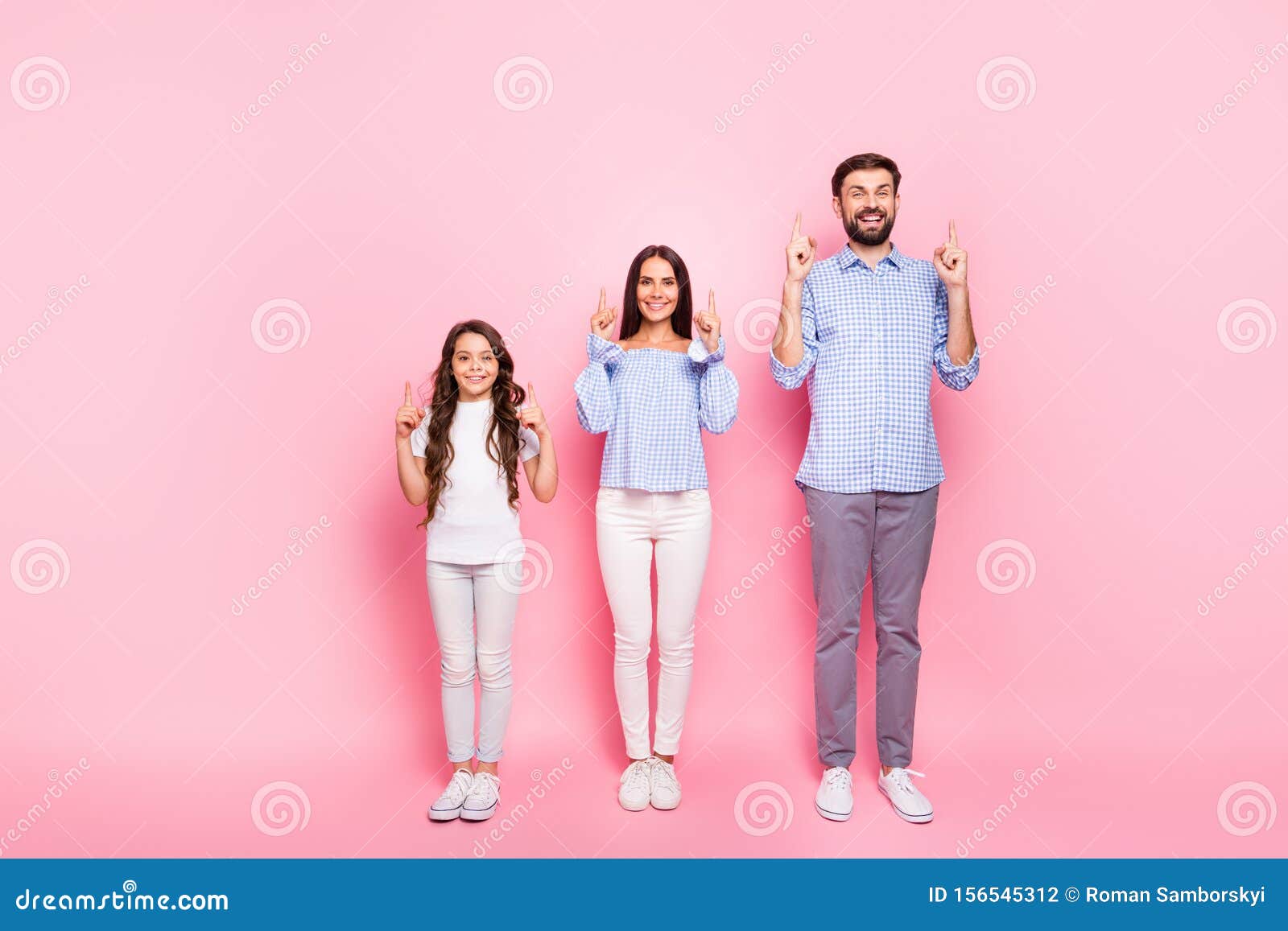 Full size photo of cheerful parents and child with wavy long haircut point at copy space wear plaid checkered shirt. Full size photo of cheerful parents and child with wavy long haircut point at copy space, wear plaid checkered shirt blouse t-shirt isolated over pink background