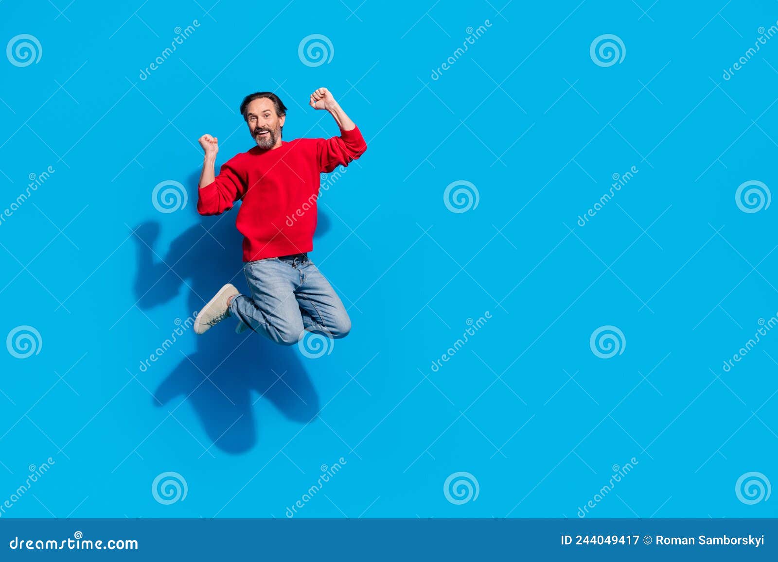 Full Size Photo Of Funky Rejoiced Male Jumping Raise Fists In Victory