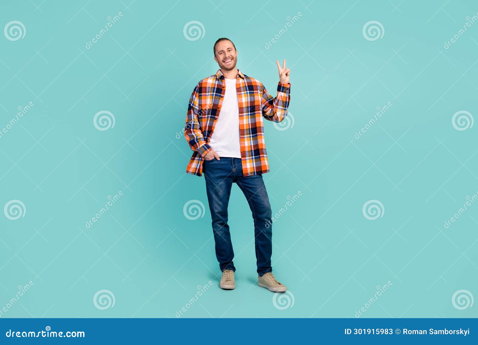 full size photo of optimistic friendly man dressed checkered shirt showing v-sign hand in pocket  on teal color