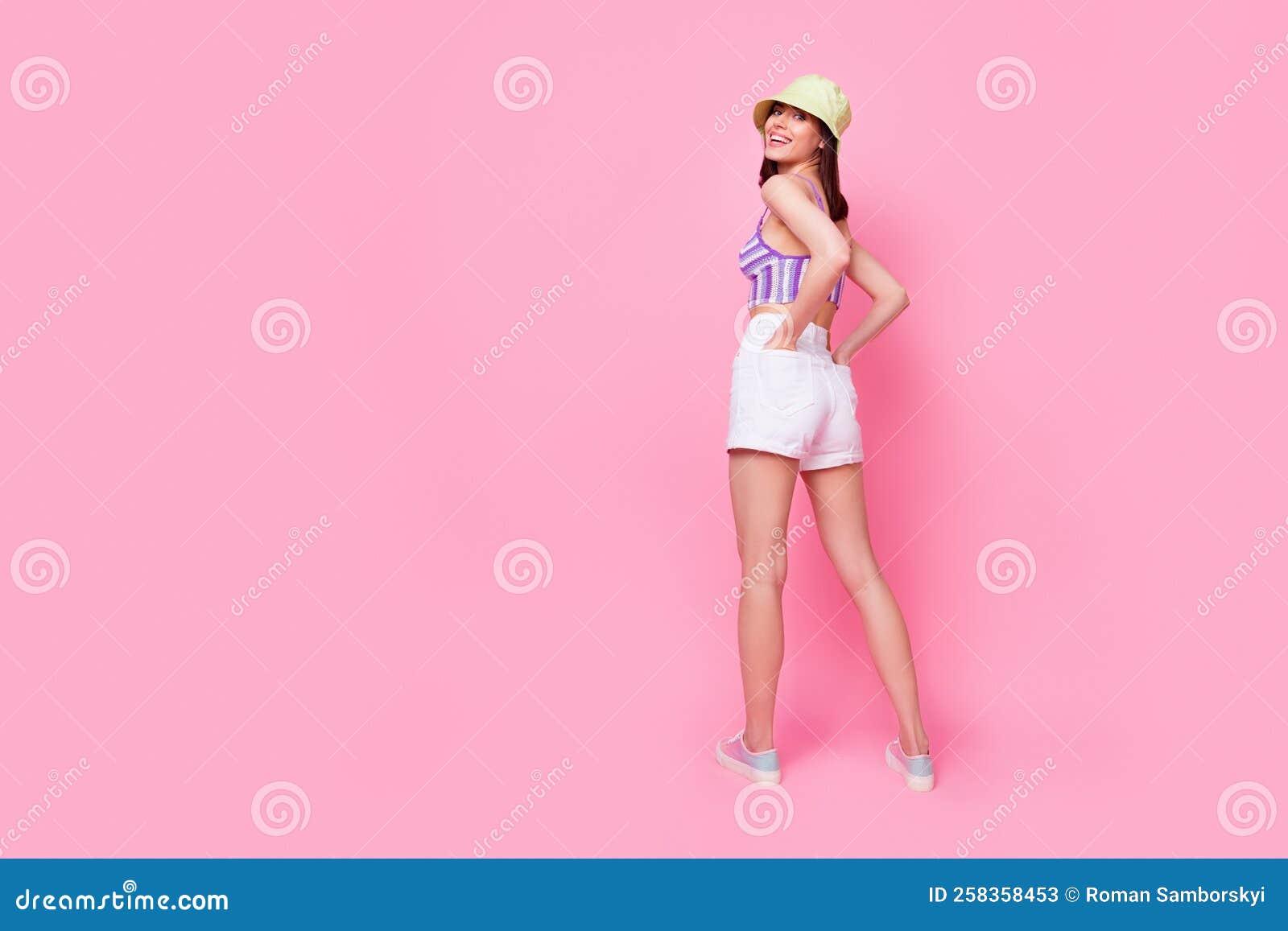 full size photo of young lady wear stylish mini shorts top hat shoes posing for new magazine  on pink color