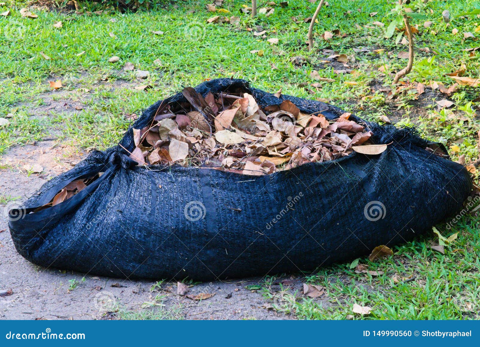 A Full View Of A Black Plastic Weaved Tarp Filled With Brown