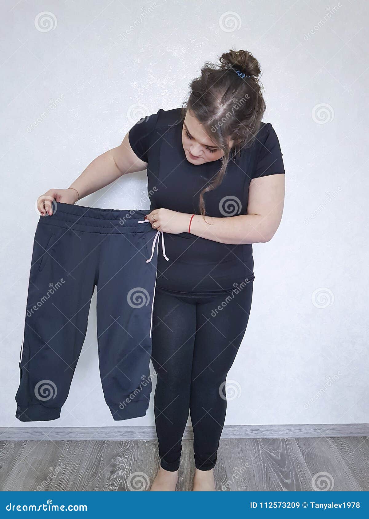 Full Woman Tries on Too Small Pants Lose Stock Image - Image of