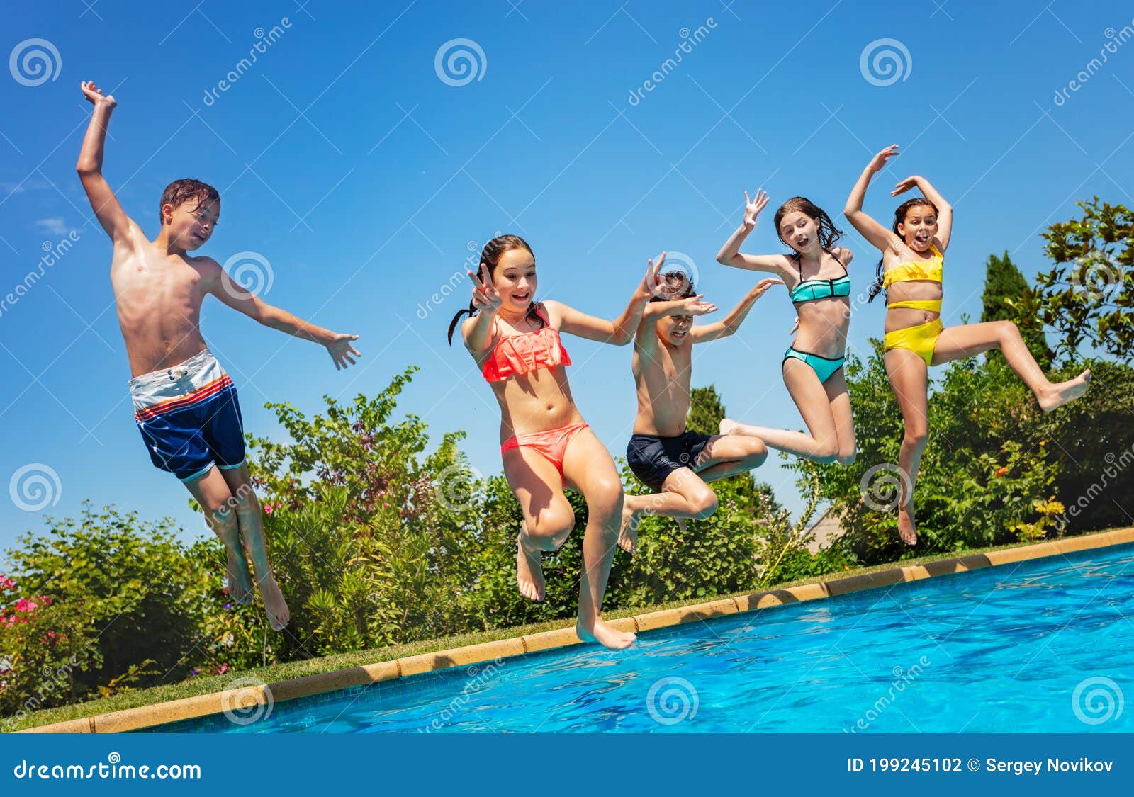 fun in the pool group of kids jump inside water