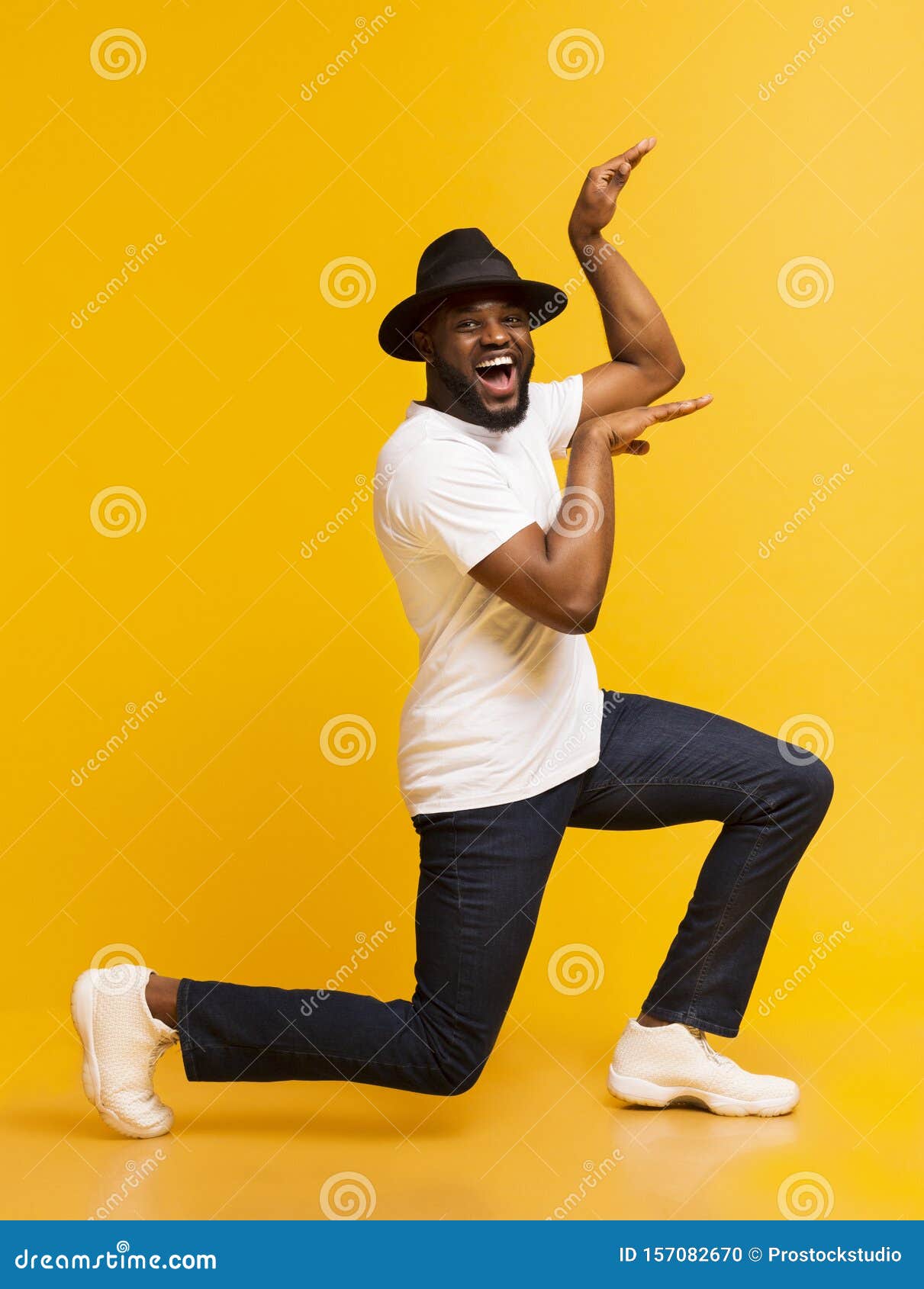 Funny African Guy Dancing in Egypt Style on Yellow Background Stock ...
