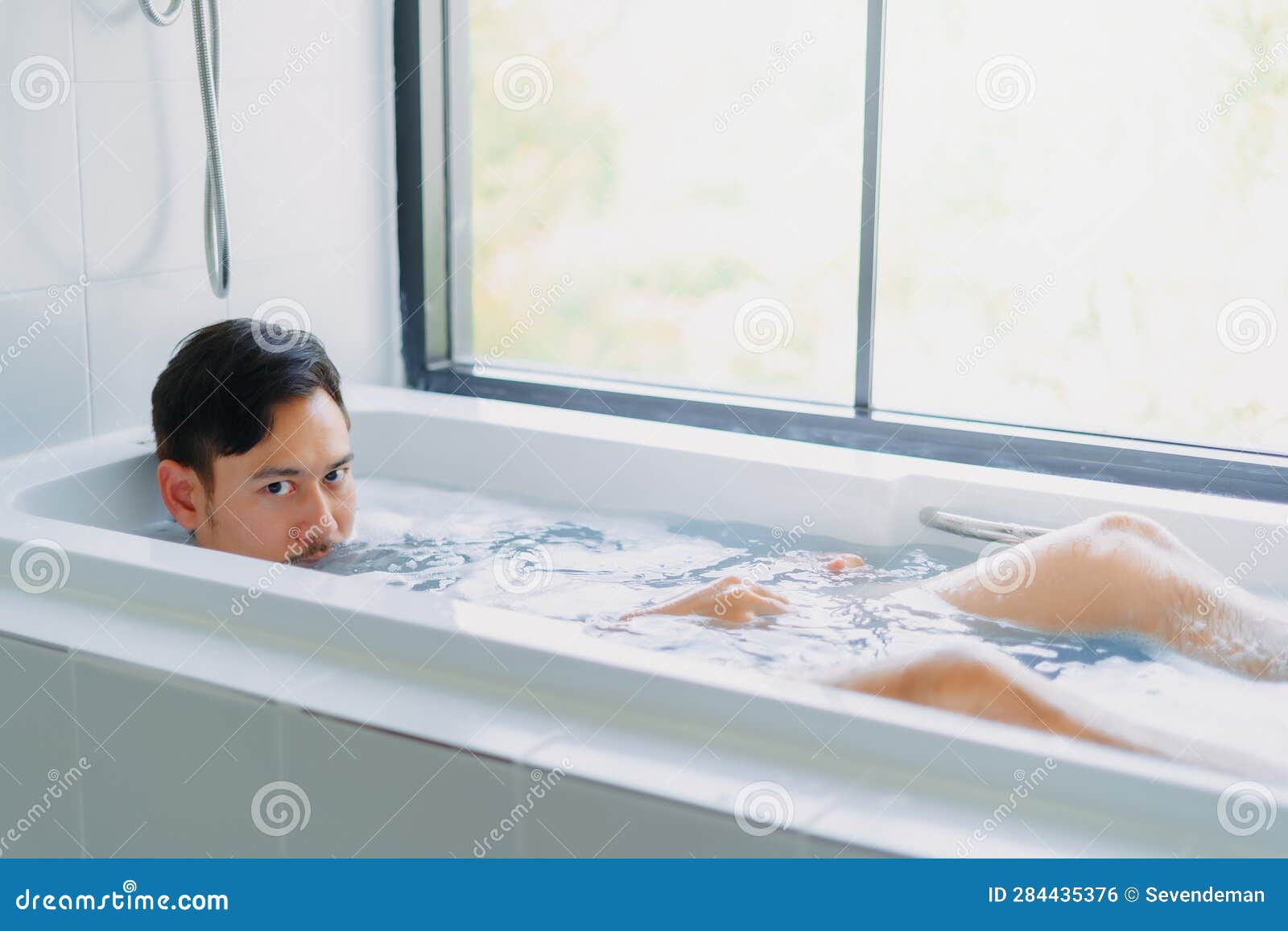 Funny Asian Man Play and Pose in the Bathtub Bathroom. Stock Photo Image of beautiful