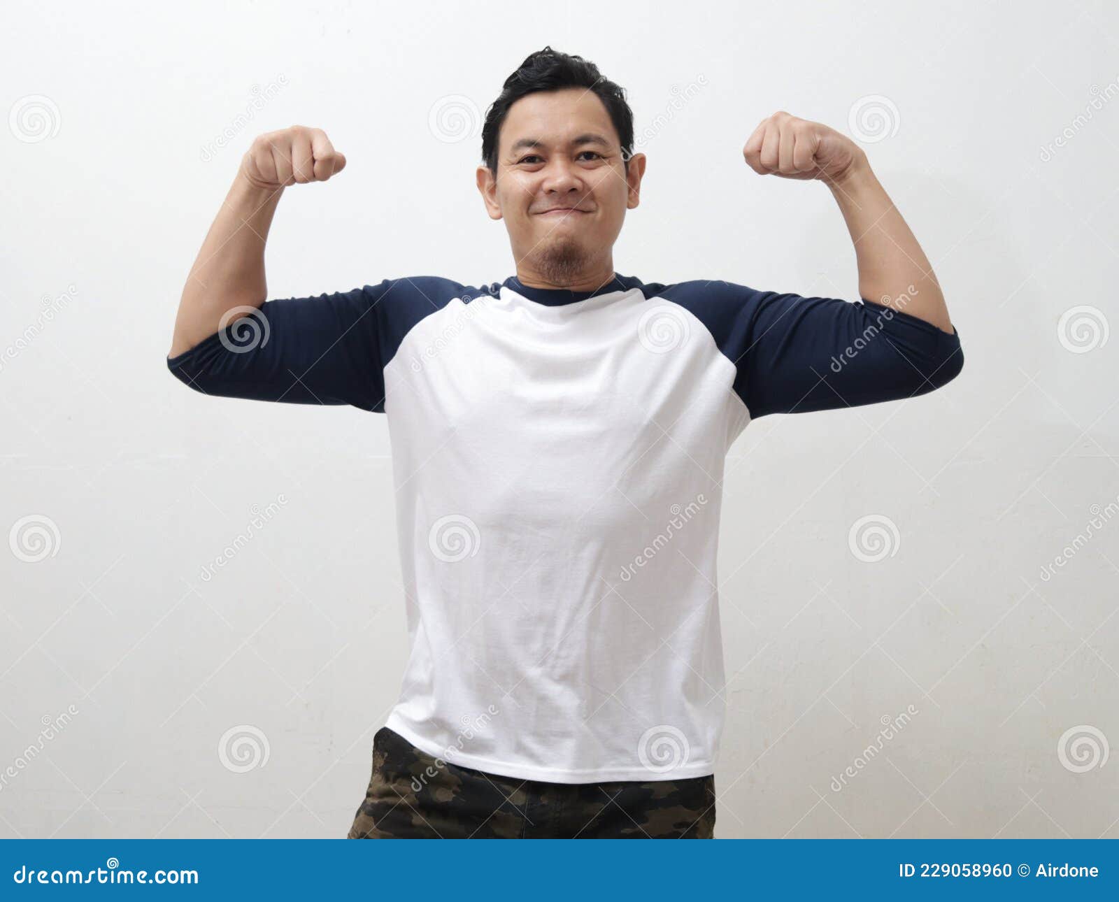 funny asian man shows double biceps pose pretending to be a strong person physically and mentally, showing self confidence