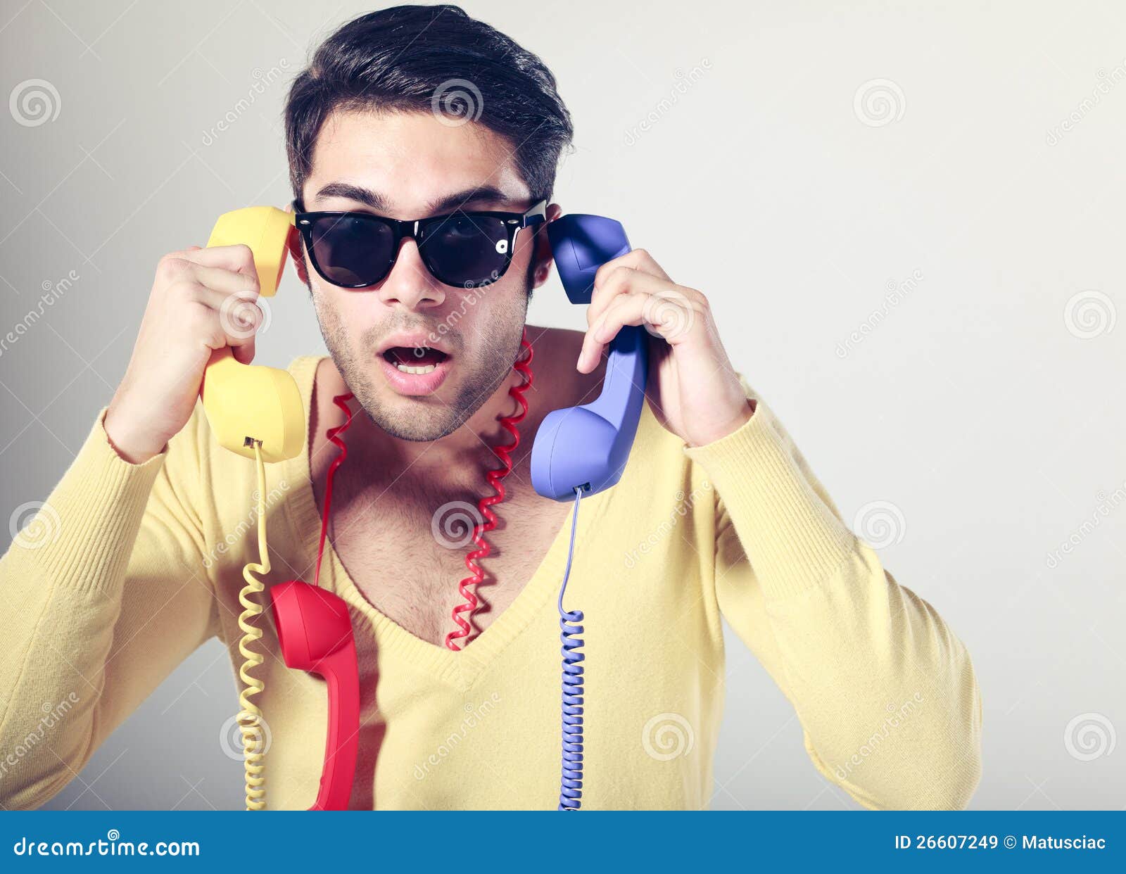 Funny Call Center Guy With Colorful Phones Stock Image - Image of cool