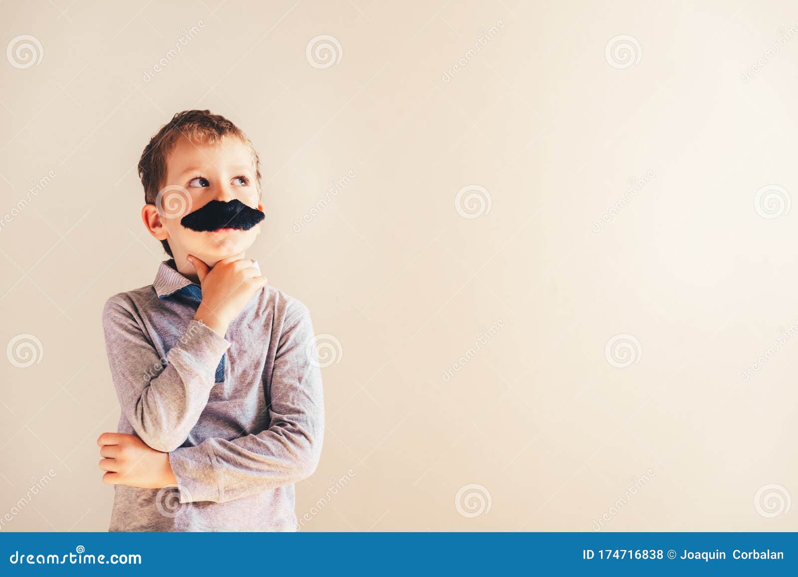 funny child with fake mustache gesturing like an adult man, maturity and business concept