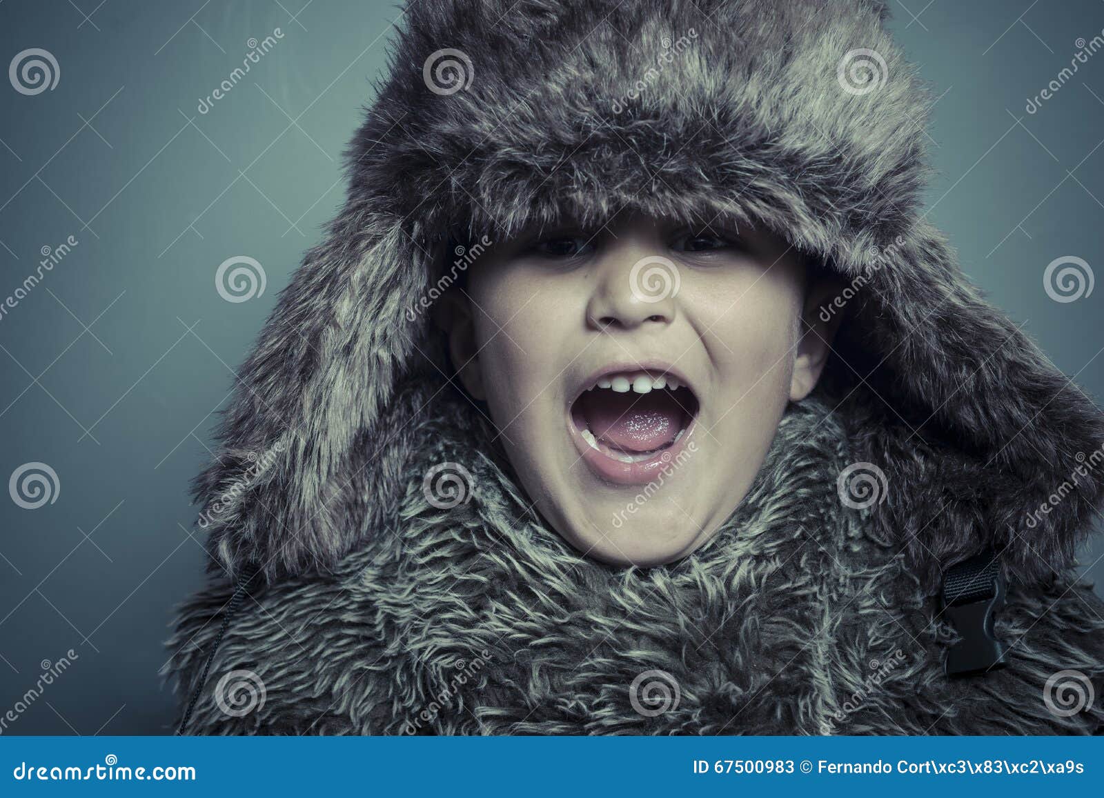 Funny Child with Fur Hat and Winter Coat, Cold Concept and Storm Stock