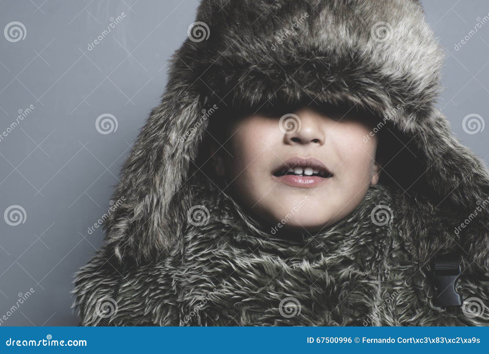 Funny Child with Fur Hat and Winter Coat, Cold Concept and Storm Stock