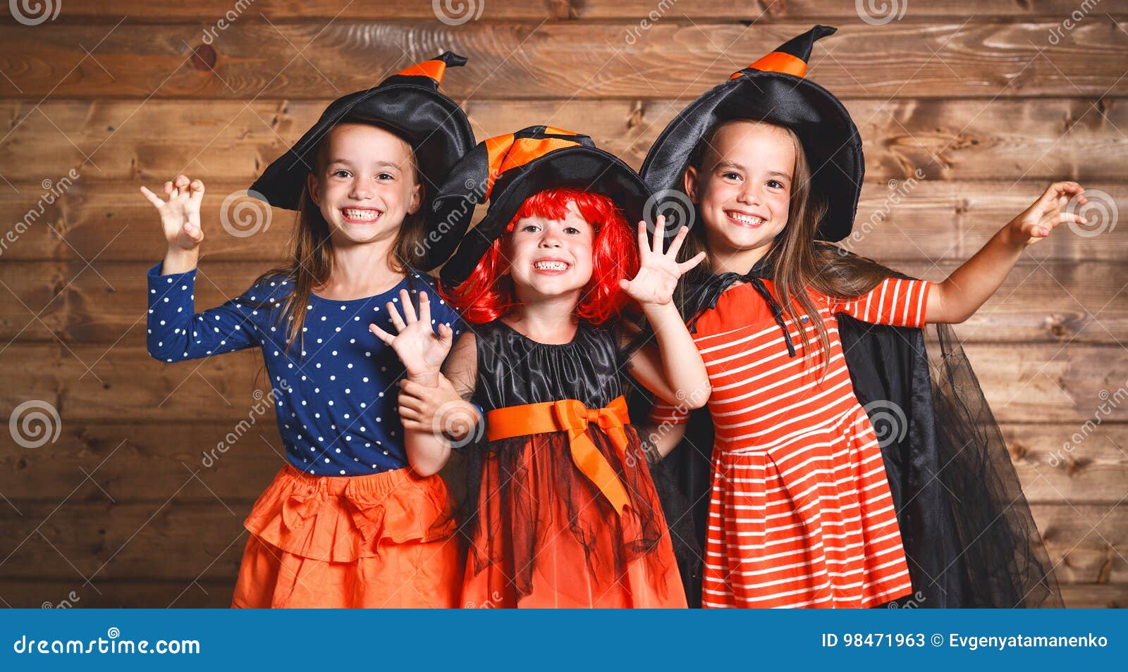 funny children sister twins girl in witch costume in halloween