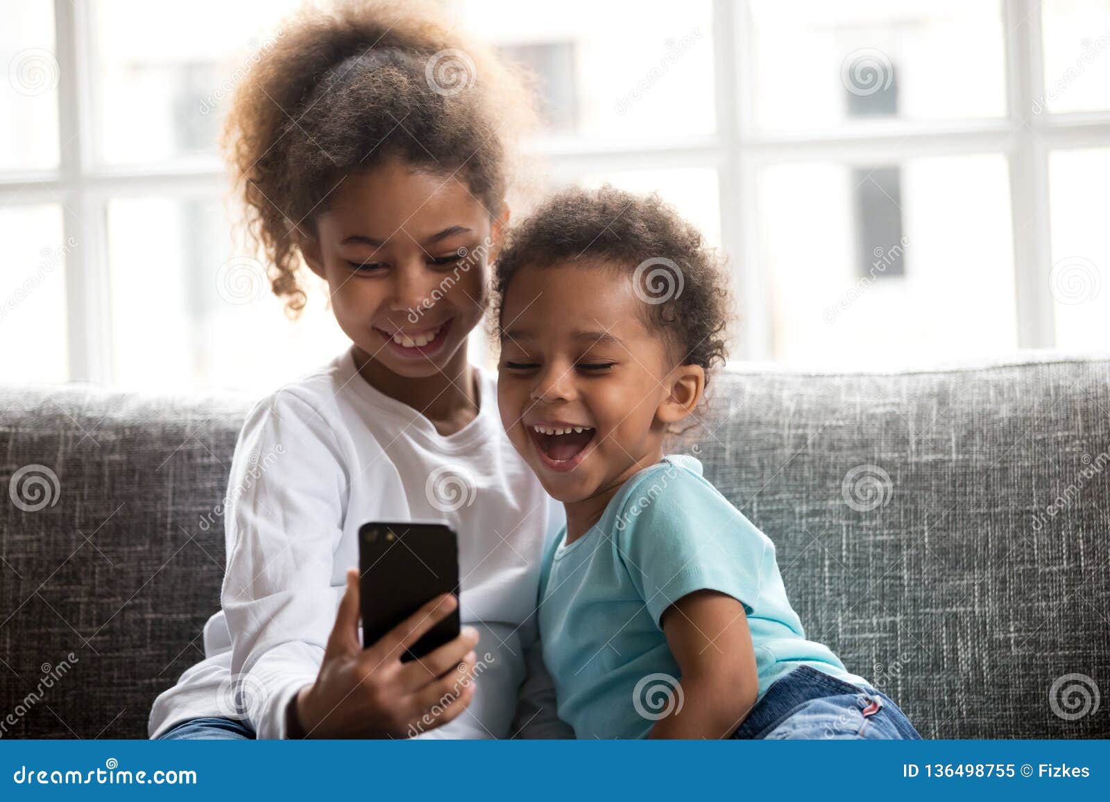 2 Funny Children Using Smartphone Watching Video Laughing on Cou Stock  Image - Image of application, laughing: 136498755