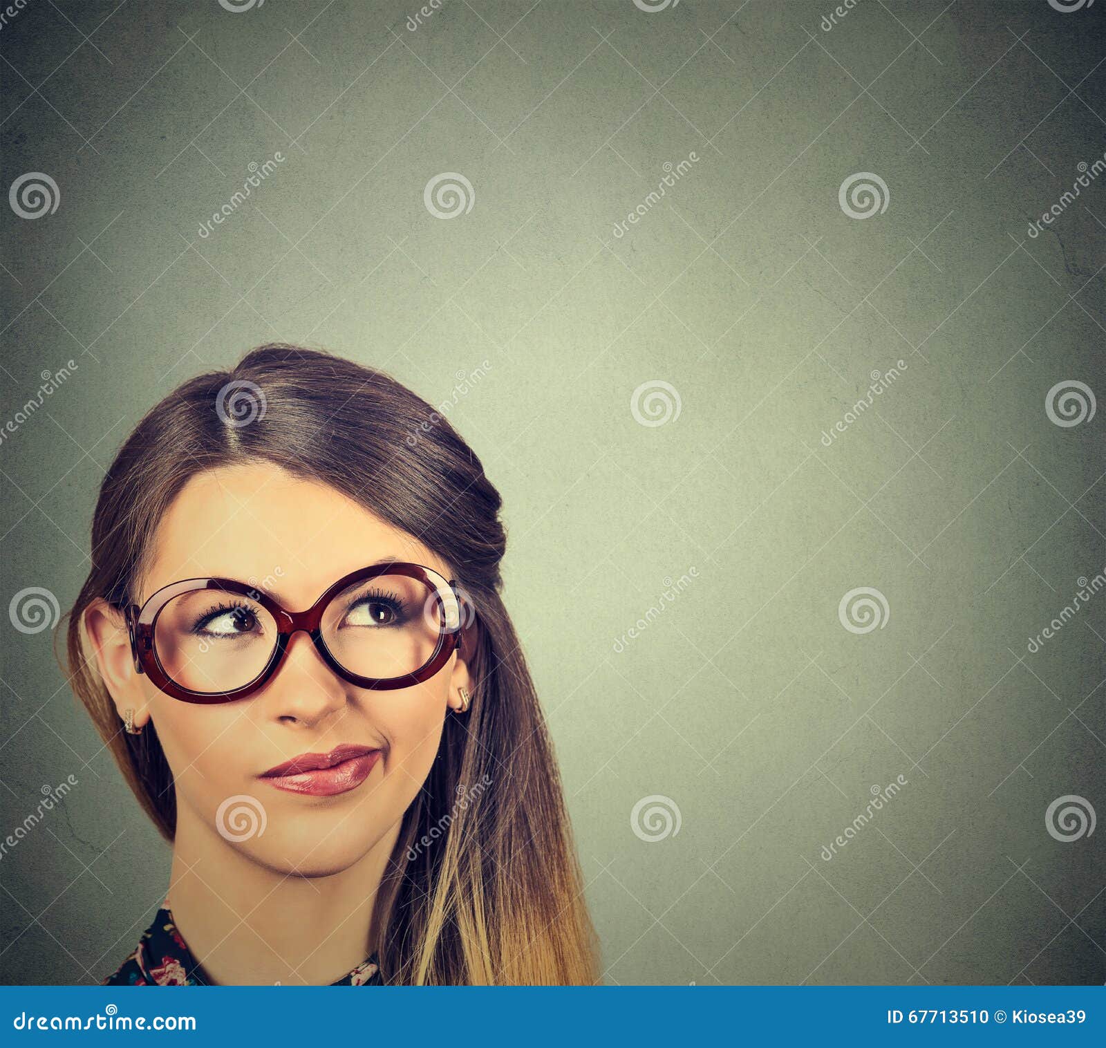 funny confused skeptical woman in glasses thinking planning looking up